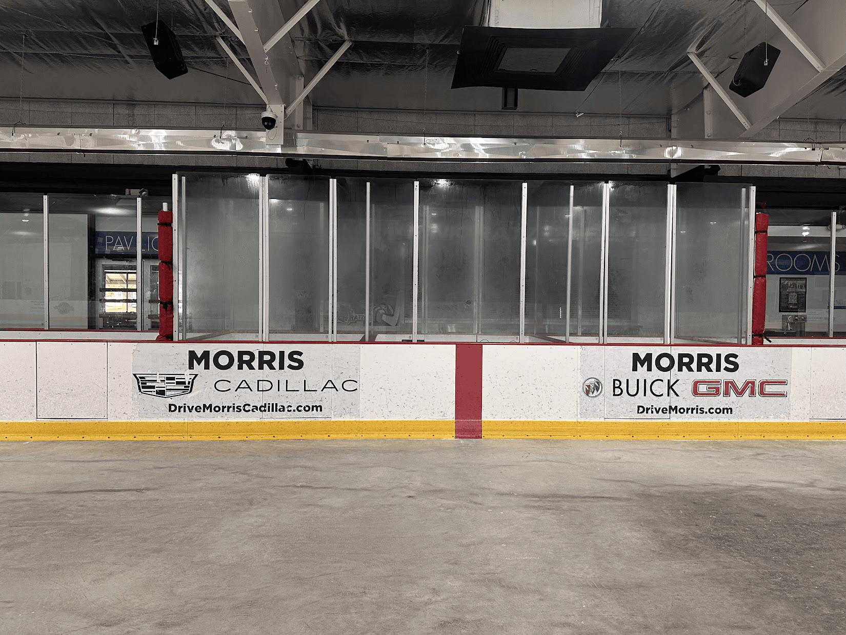 Sponsor signage on the dasher boards along the rink